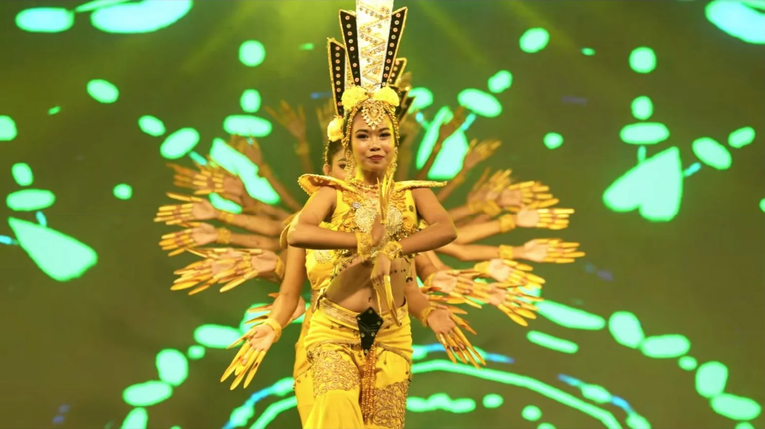 A dancer in gold performing on stage
