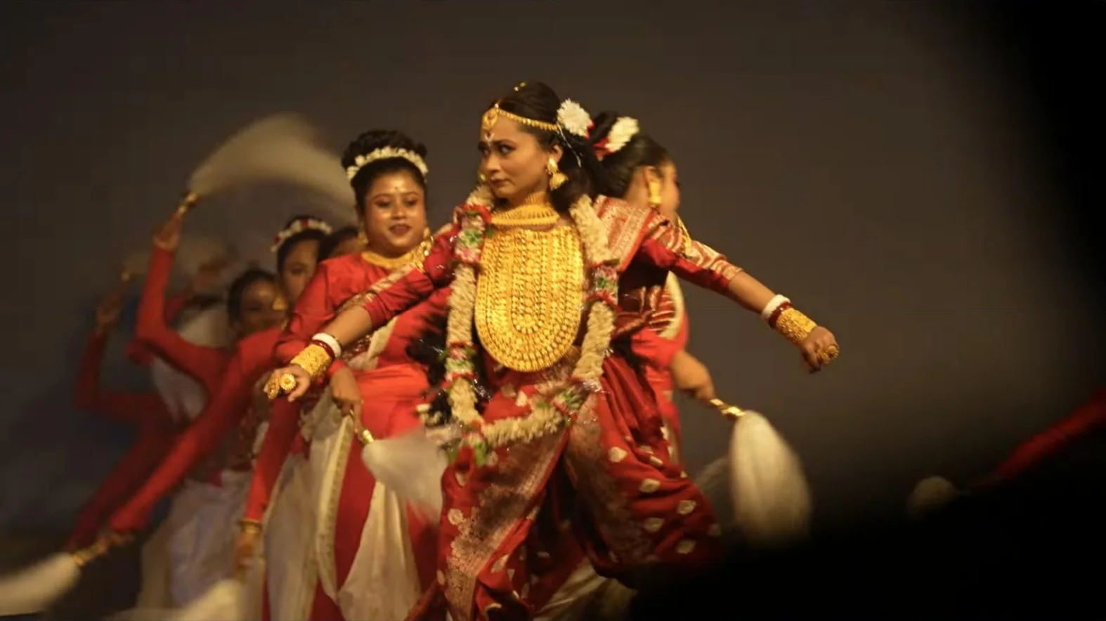 Dancers in red and gold performing